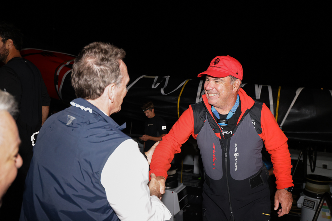 On the dock at Falmouth Marina, Antigua - RORC CEO Jeremy Wilton congratulates Mitch Booth, Skipper of Comanche © Arthur Daniel/RORC